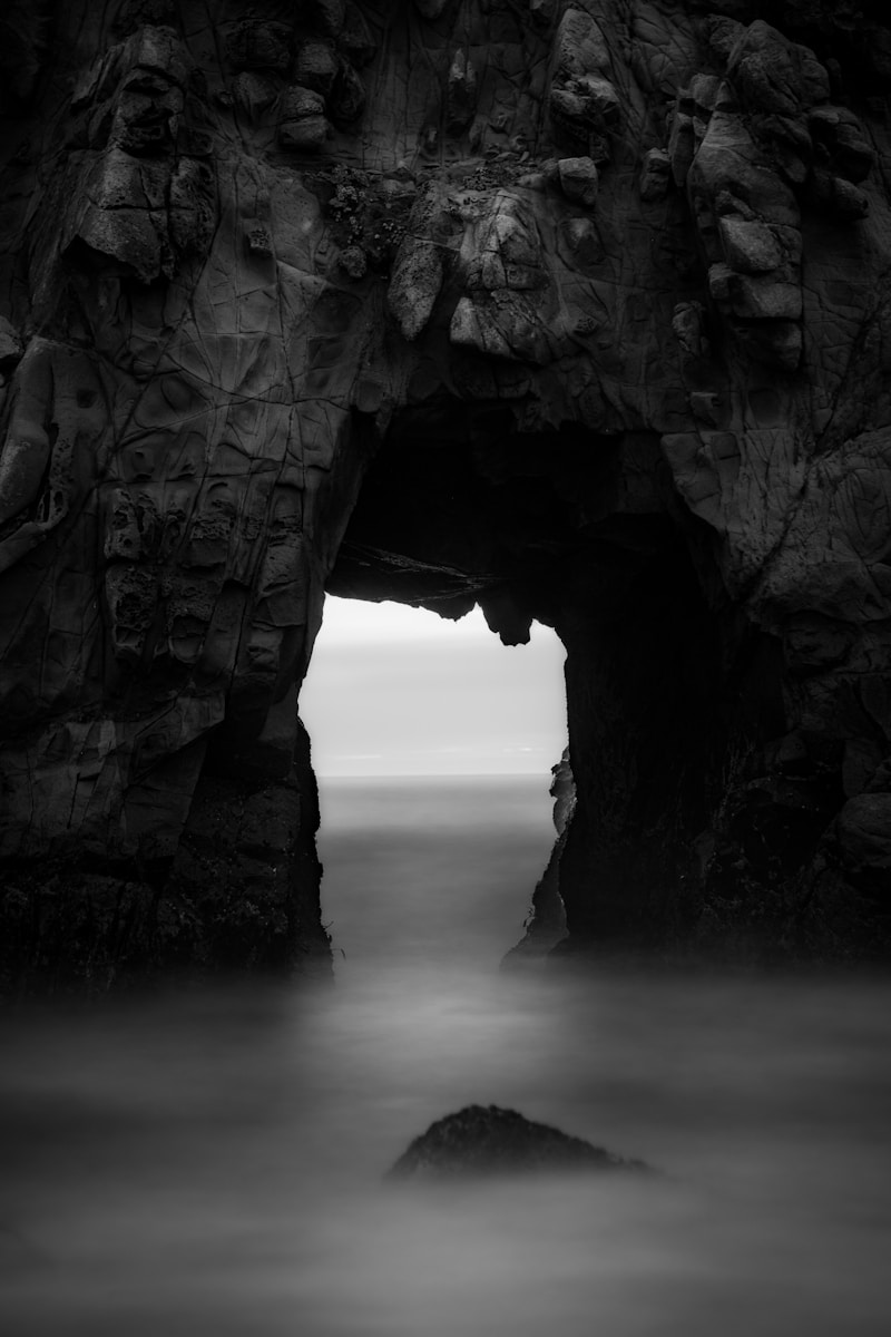 Sea cave opening with ocean view and rock
